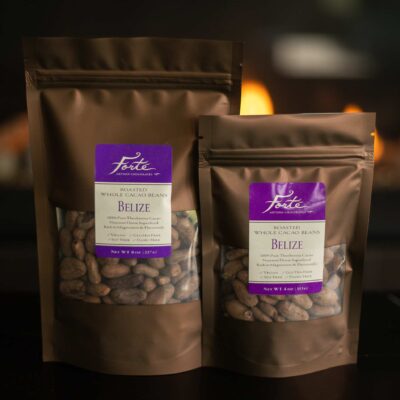 Two brown bags of differing sizes with purple labels of roasted whole cacao beans from Belize with flames in the background