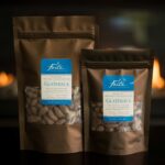 Two brown bags of differing sizes with blue labels of roasted whole cacao beans from Guatemala with flames in the background