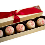 5 piece box of seasonal peppermint truffles with red ribbon