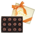 12 piece box of classic dark chocolate truffles in cream box with orange ribbon