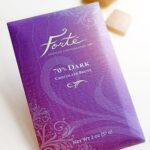 Forte 70% dark chocolate bar packaging in bright purple with chocolate squares in background