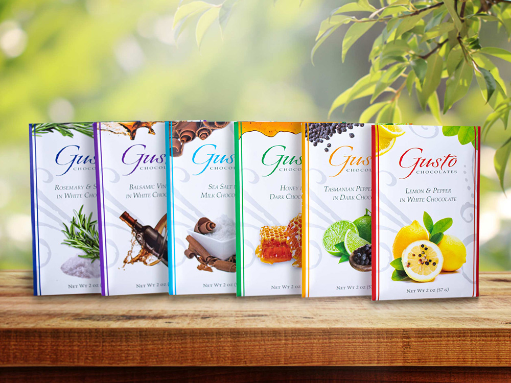 6 chocolate bars from the Gusto Chefs Delight collection with trees in background