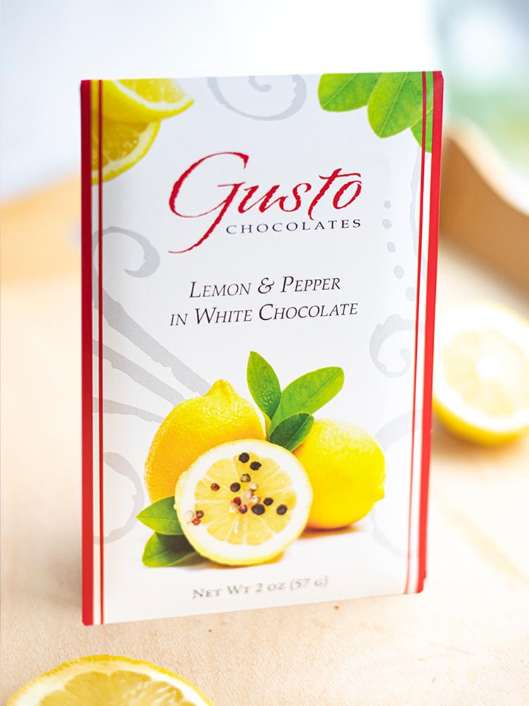 Gusto lemon and pepper in white chocolate packaging showing lemons and leaves
