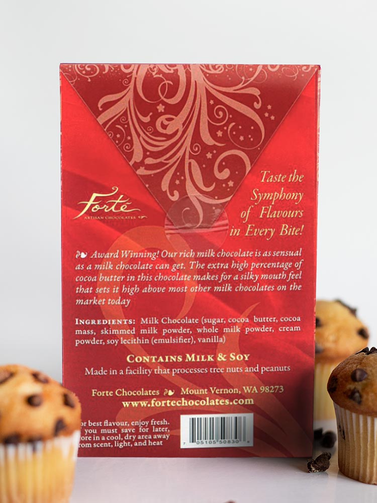 Back of Milk Love bar standing among 3 chocolate chip muffins
