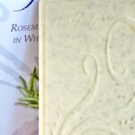 Close up of rosemary sea salt in white chocolate bar and packaging