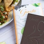 Gusto Tasmanian Pepper Lime bar sitting on top of packaging with tacos and cut limes in background