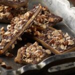 Close-up of almond toffee butter crunch arranged on an antique silver tray