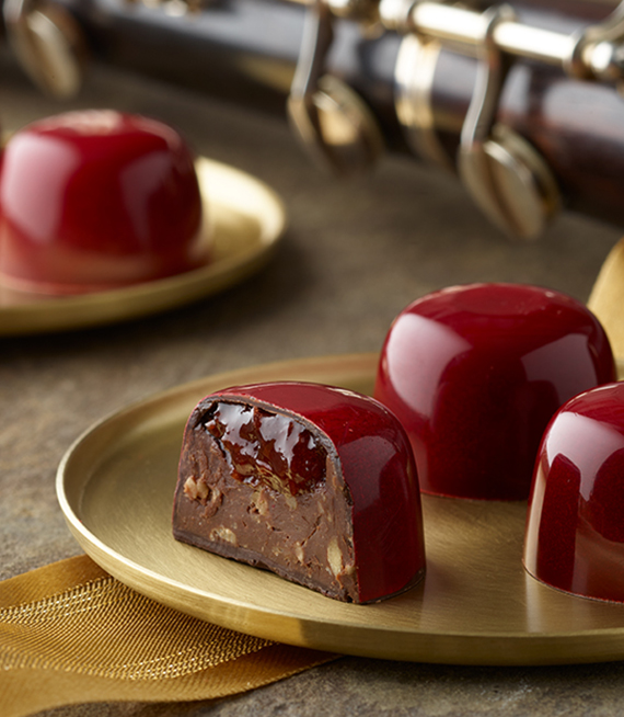 Beautiful Cherry Almond truffles on gold round plate with clarinet in background